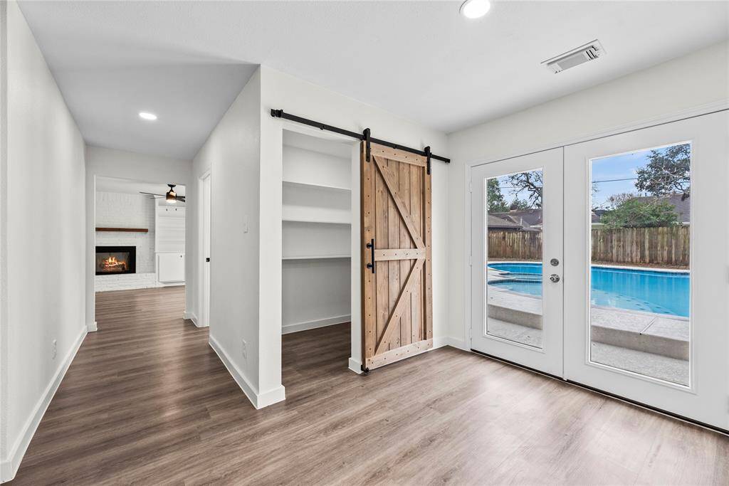 Walk-in pantry with a barn door.