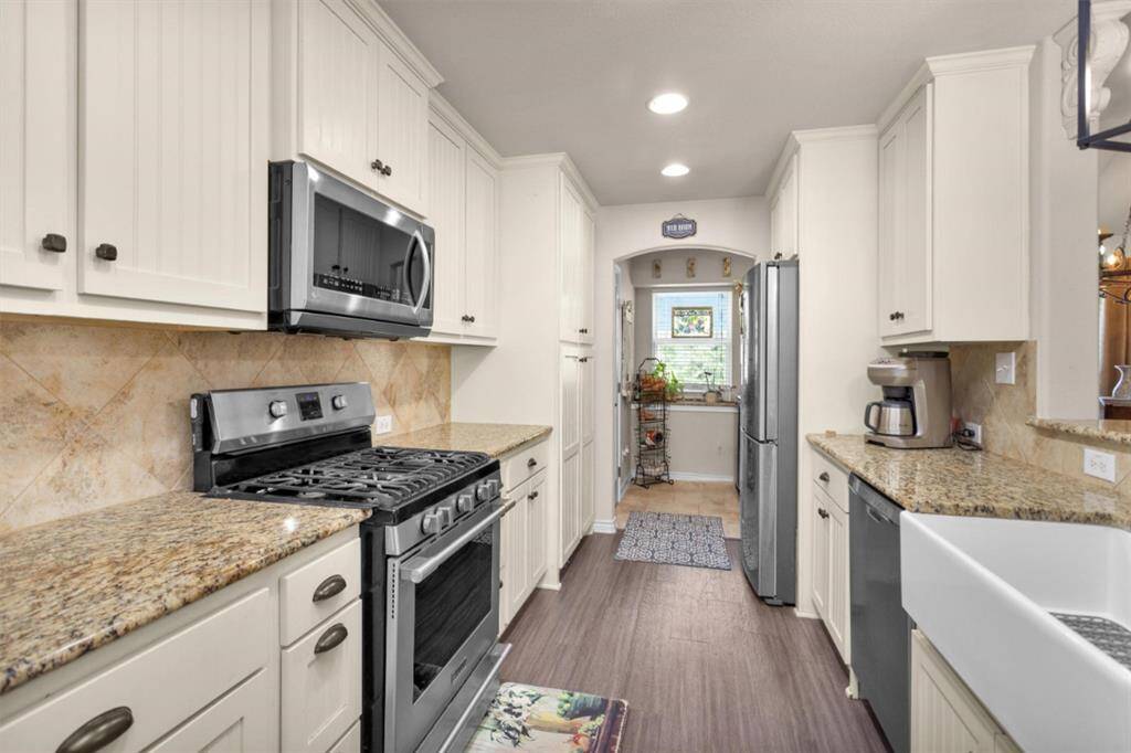 View of kitchen to utility room and pantry.