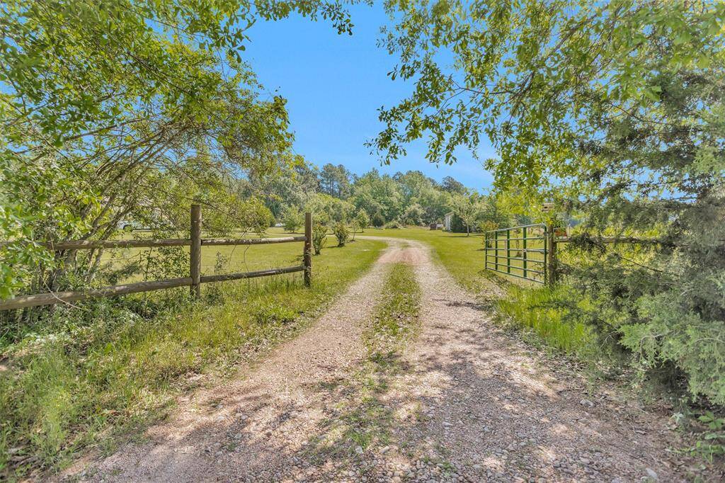 Gated entry and trees along fence line for added privacy.