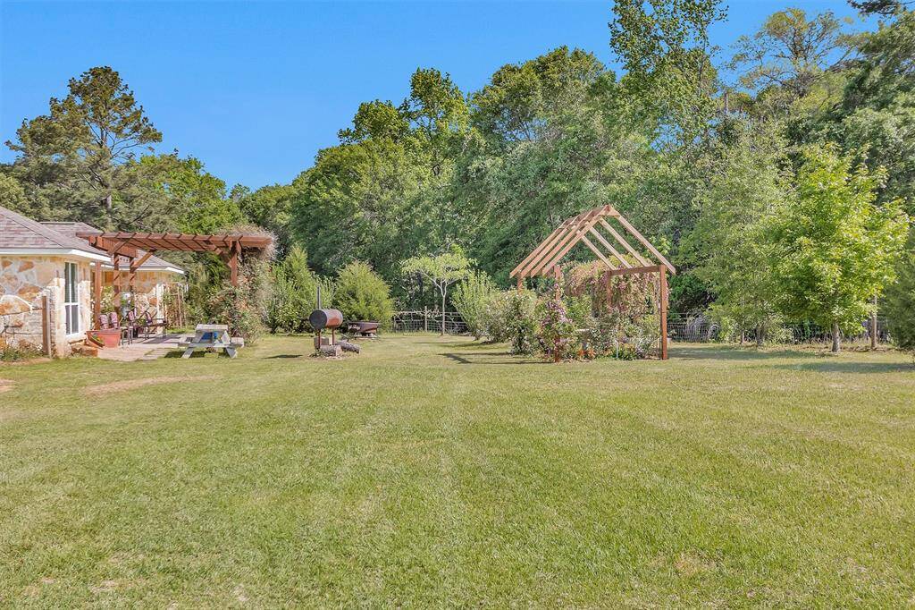 Side view of your back yard to the house.  The BBQ pit does not stay with house.