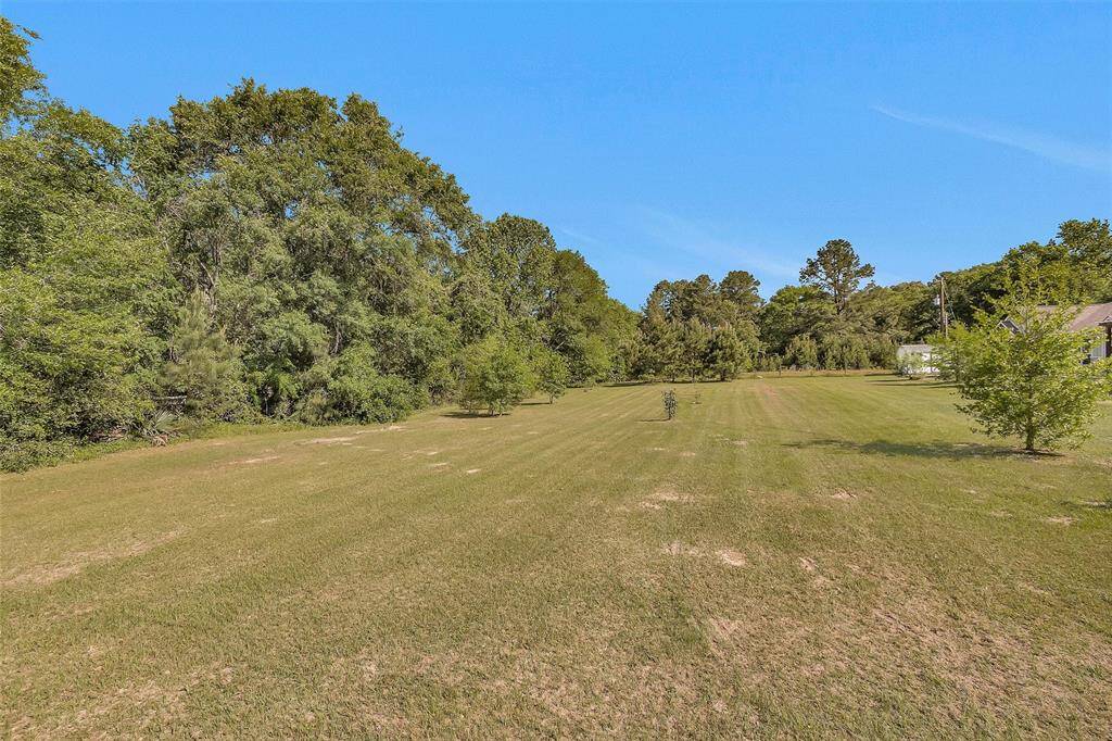 Road frontage is lined with trees an shrubs along fence to provide extra privacy.