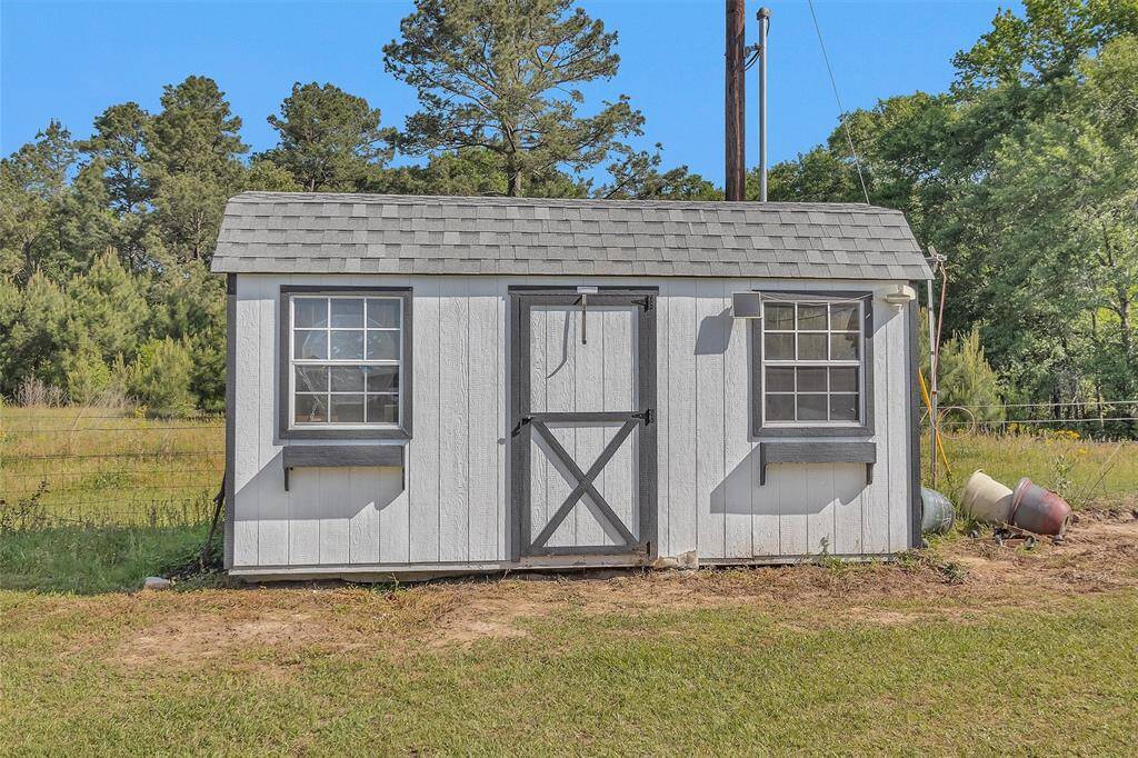 "She Shed" on left side of property. It is  16X7.5 and has power to it.   Property fence line is behind shed.  No neighbors on the left or back side of home.