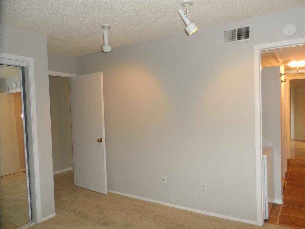 Primary room with light gray walls, this room is set up for functionality, ideal for a bedroom or home office.