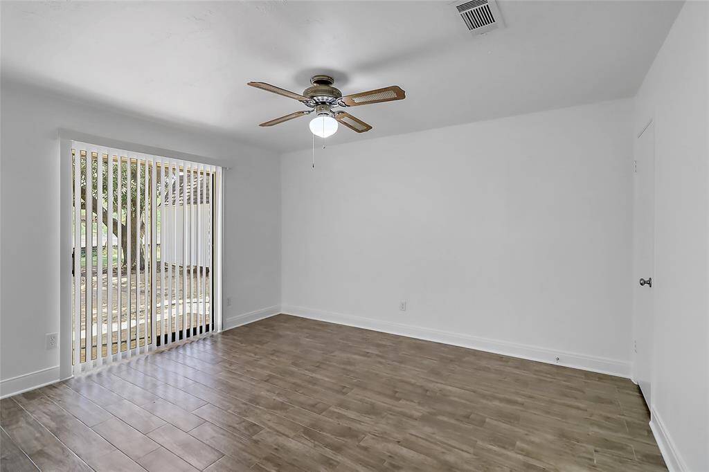 This beautifully appointed master bedroom features a private door that opens directly to the outdoors, allowing you to step out and enjoy fresh air and scenic views at any time.