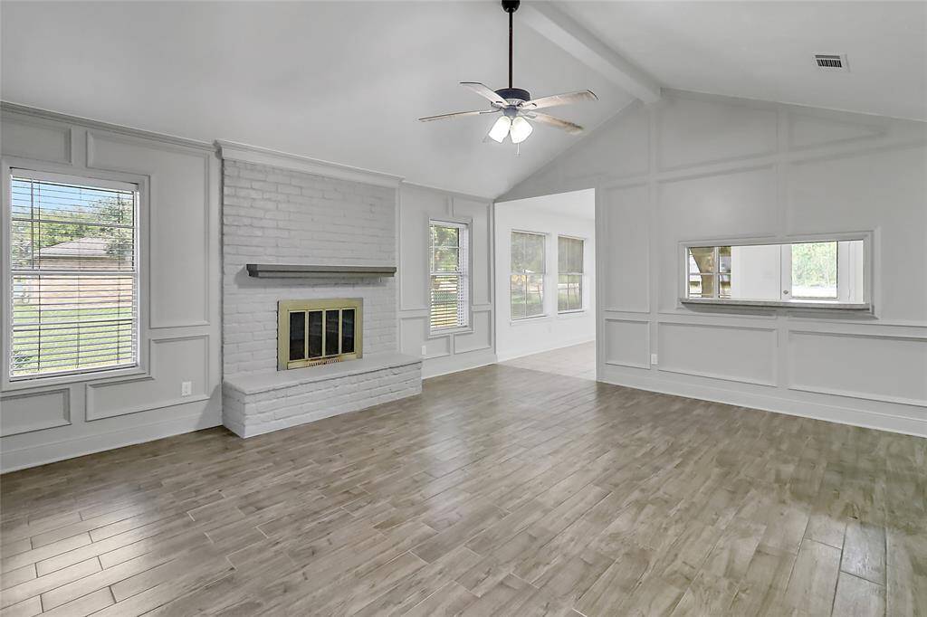 Welcome to a beautifully appointed living room where comfort and elegance meet. The centerpiece of this inviting space is a classic fireplace.