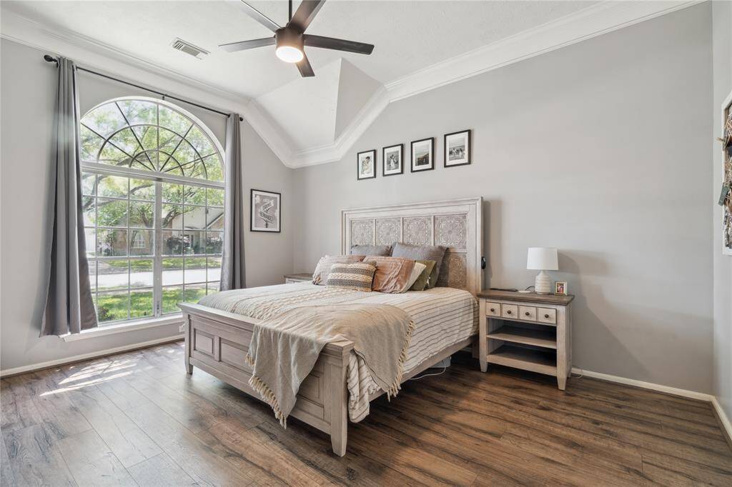 Retreat to your serene and stylish primary suite, where vaulted ceilings and a dramatic arched window make a statement.