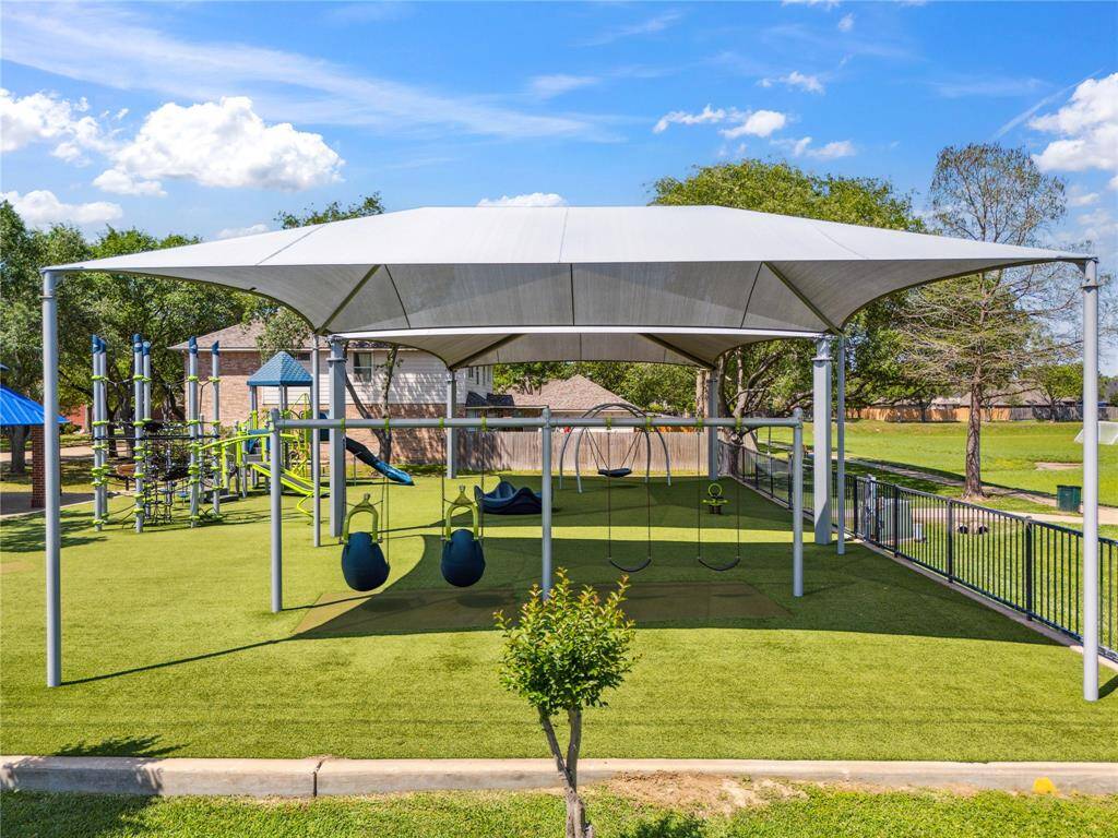 This shaded swing area is part of the playground design that makes playtime comfortable even in the heat. A thoughtful touch for families who spend time outdoors.