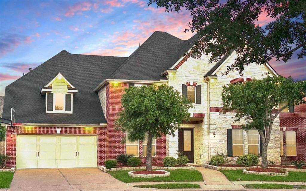 Experience the captivating curb appeal of this home's front exterior, featuring striking white stones and elegant brickwork.