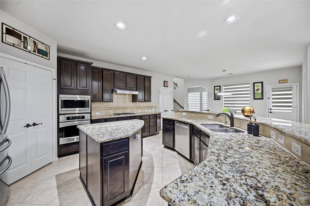 Modern, spacious kitchen with stainless steel appliances and a dual sink—ideal for family gatherings.