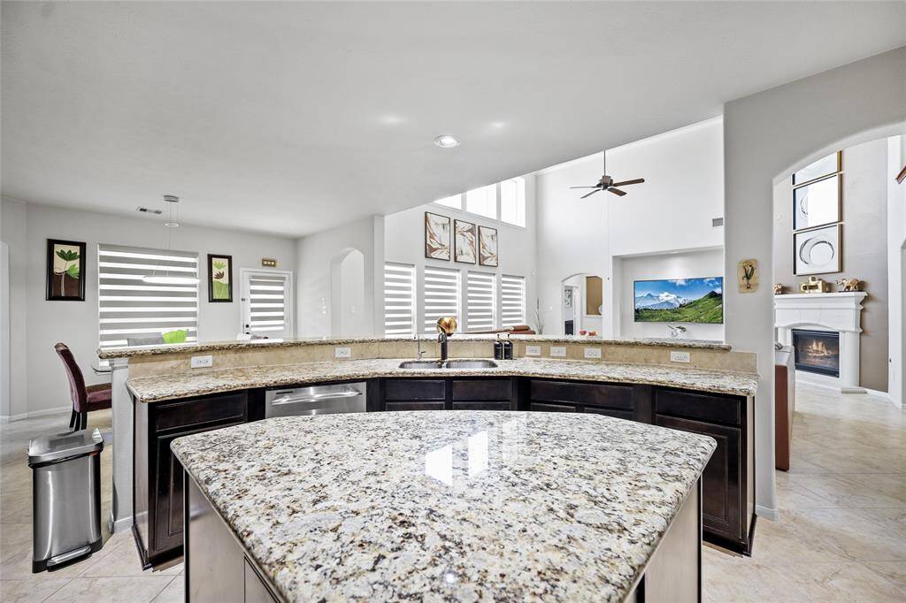 This spacious, open-concept kitchen flows seamlessly into a bright living area.