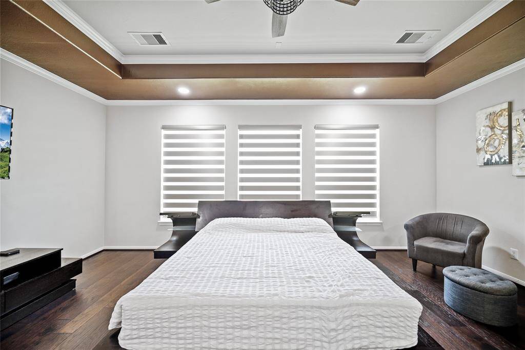 Elegant primary suite with cozy sitting area perfect for relaxation.