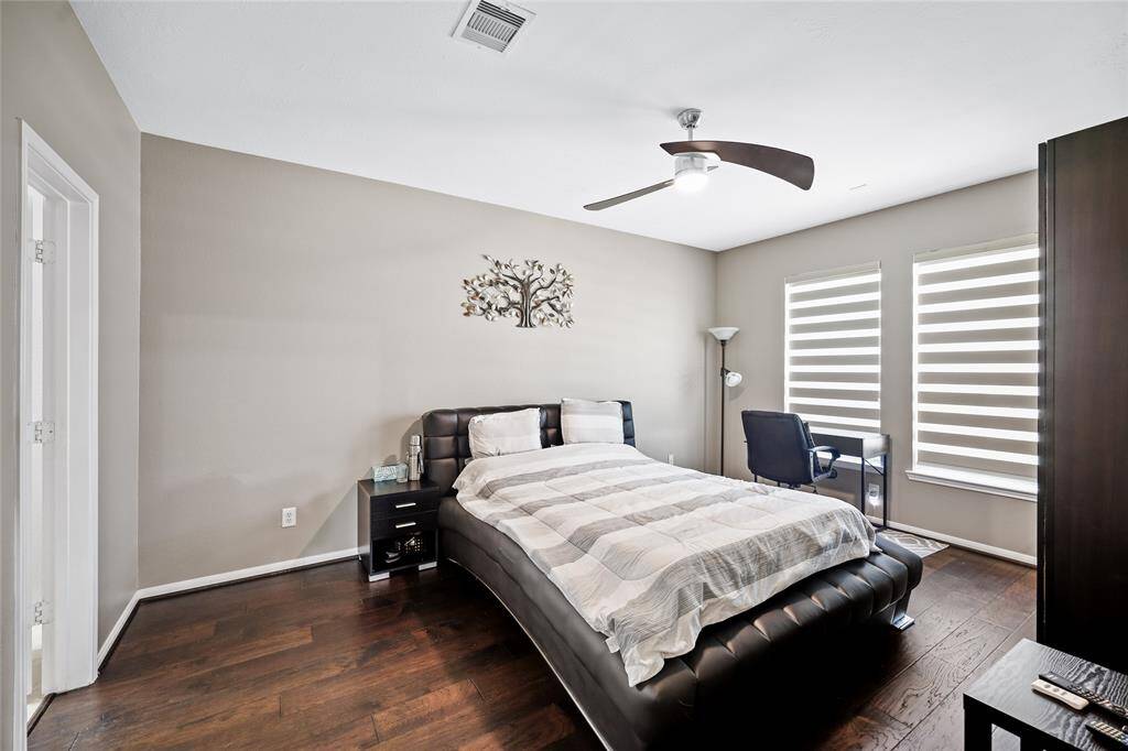 Bright downstairs guest bedroom with private bath and stunning floors.