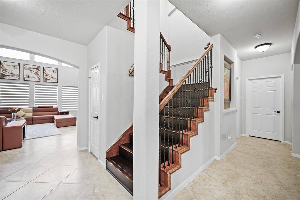 Elegant staircase with wrought iron details.