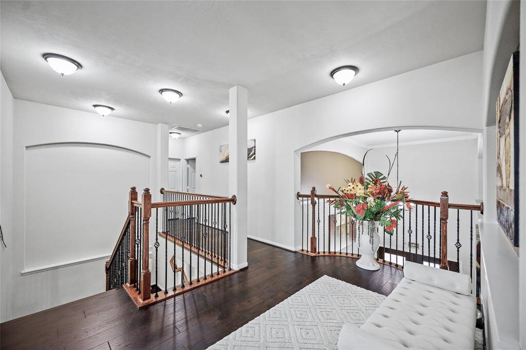 Spacious and inviting landing area at the top of the staircase, perfect for a cozy seating nook or additional decor.