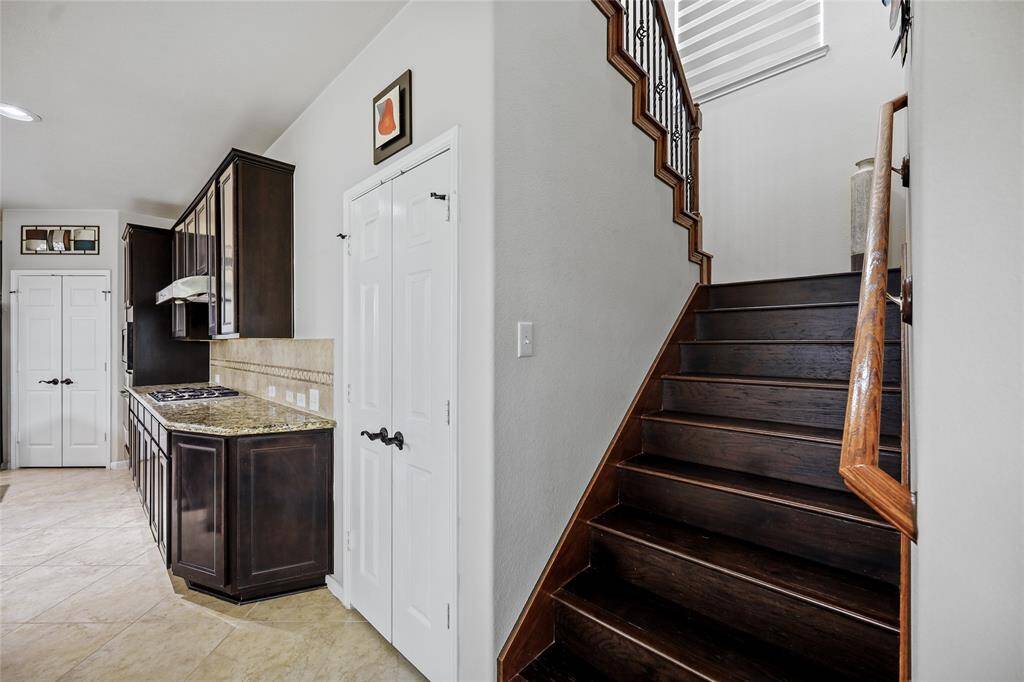 Convenient kitchen-access staircase for seamless upstairs entry.