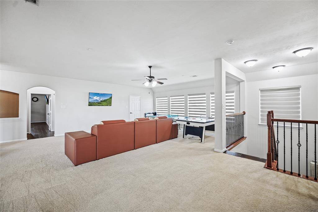 Expansive game room view from the back staircase, perfect for entertainment and relaxation.