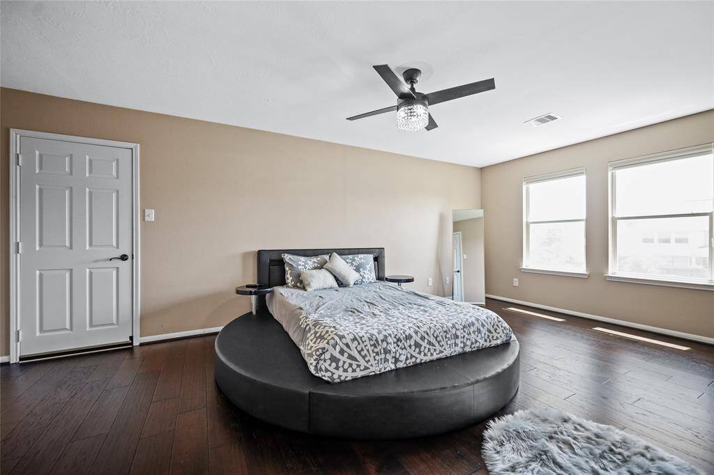 Spacious bedroom 4 featuring abundant natural light, elegant flooring, and a stylish ceiling fan for modern comfort.