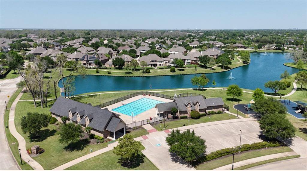 Beautiful neighborhood of the home showcasing lake, walking trails and club house.