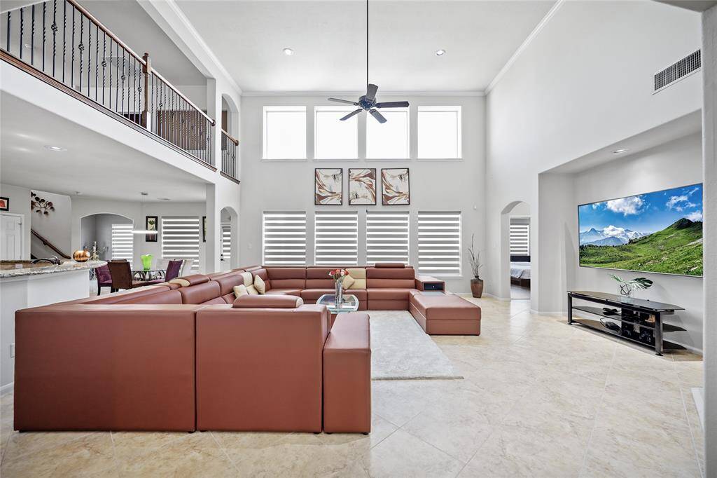 Spacious two-story family room features high ceilings and abundant natural light.