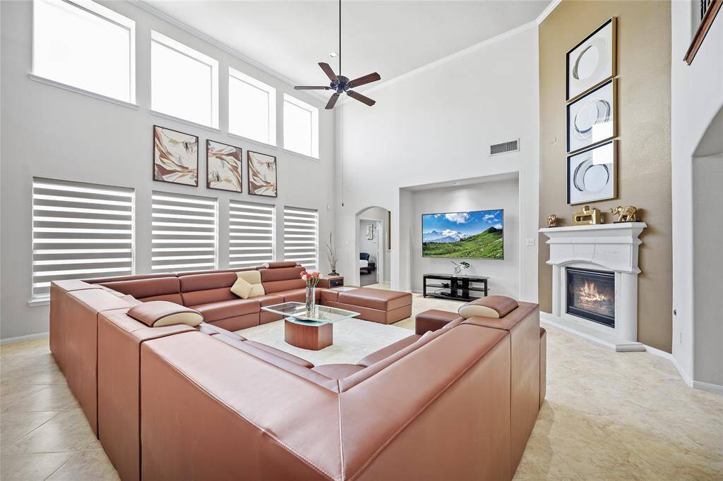 The family room has large windows and a cozy fireplace creating an inviting atmosphere for relaxation.