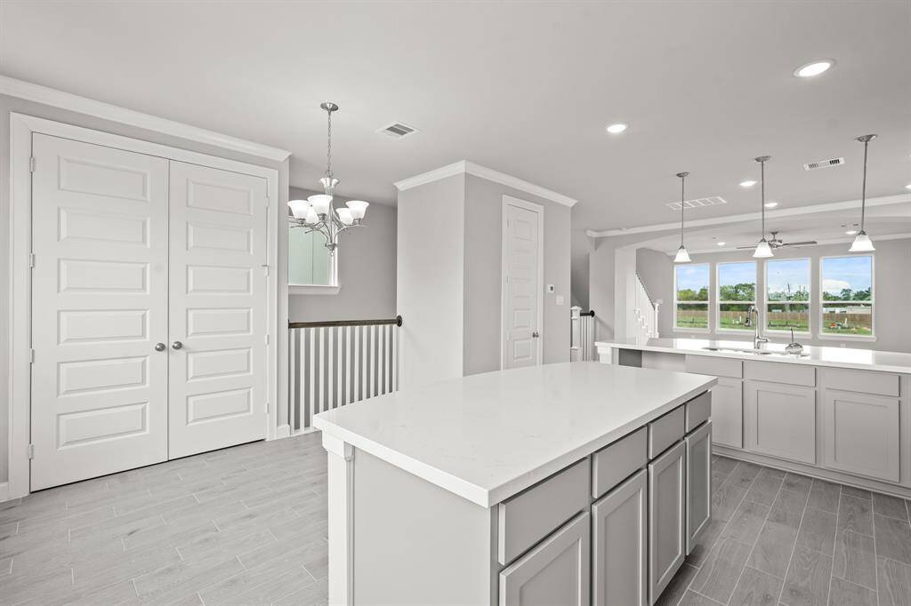 Island kitchen with cozy dining area (*Photo not of actual home and used for illustration purposes only.)