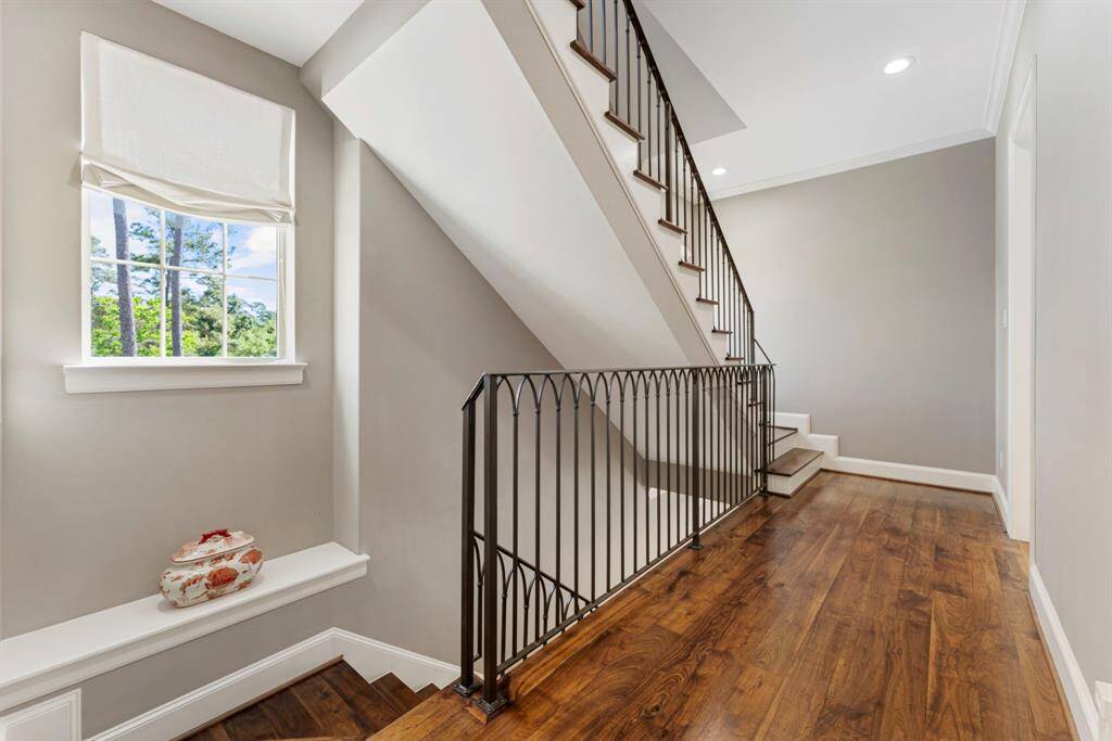 Beautiful wood flooring graces the staircase and hallways.