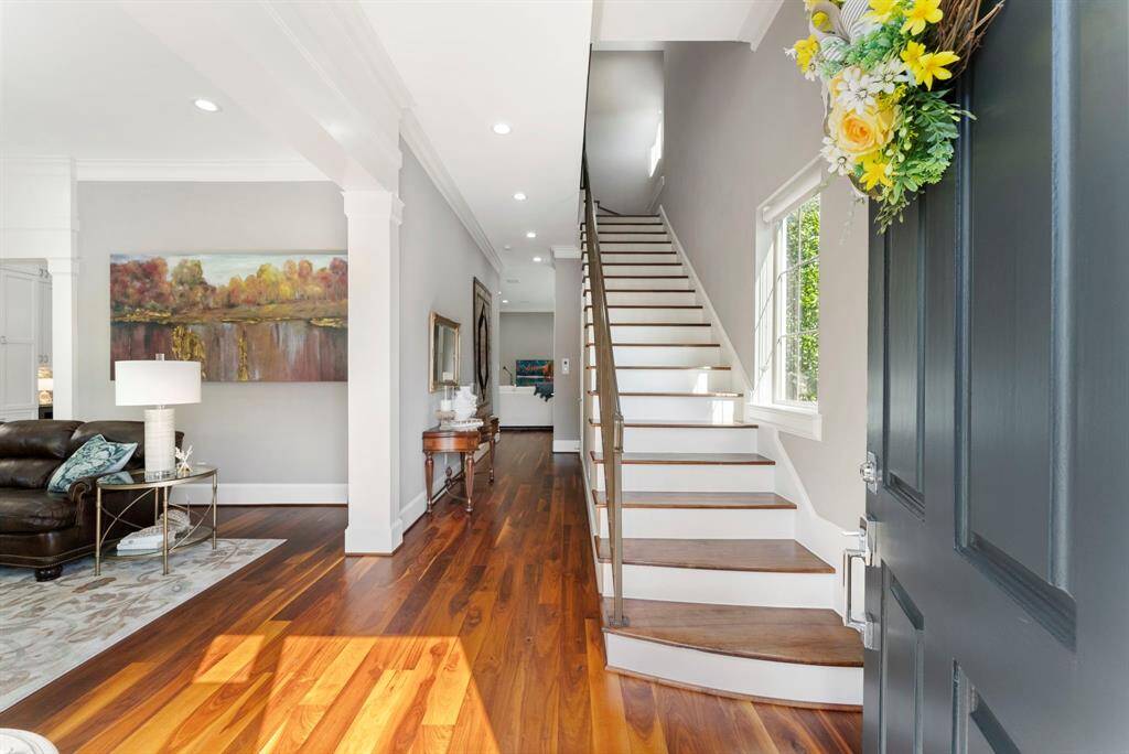 Step inside to rich wood flooring, crown molding, recessed lighting, and fresh neutral tones throughout.