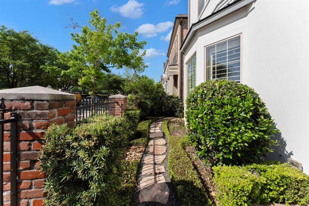Lush landscaping surrounds the property, creating a beautifully manicured setting.