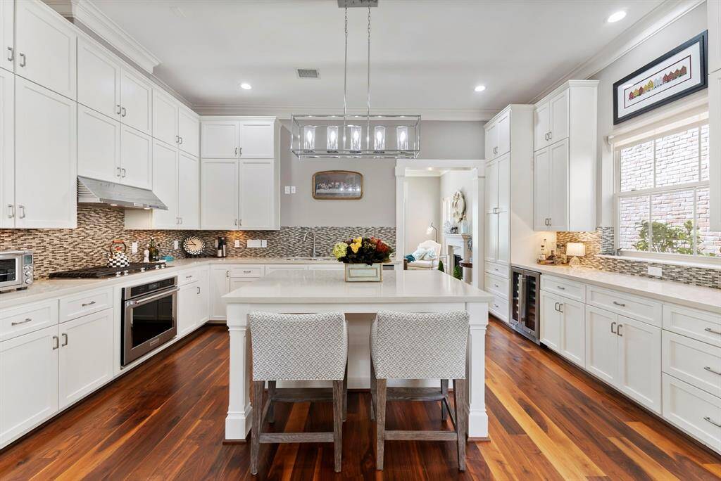 Bright and open kitchen with a large island and a lovely window view of the peaceful patio retreat.