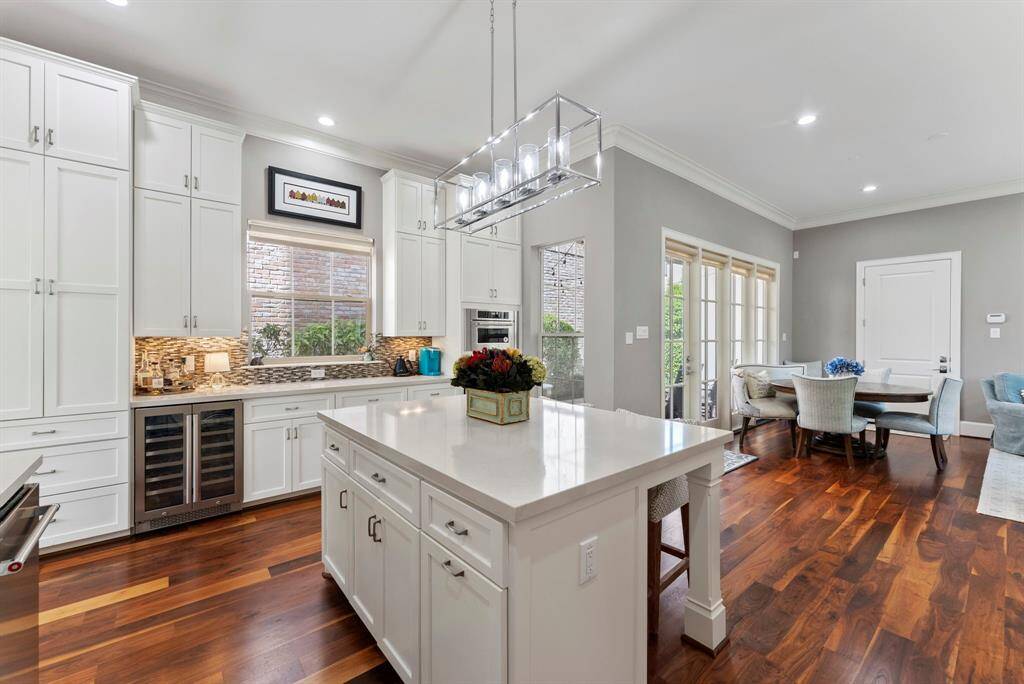 Featuring an island with seating, plus an adjacent breakfast nook with views of the patio.