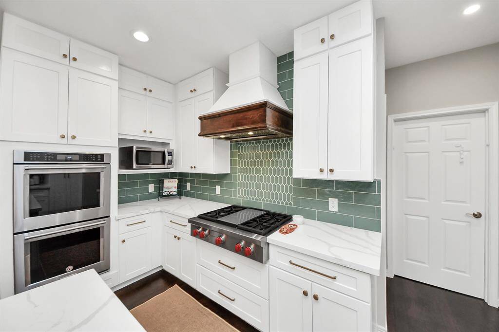 From a cooking perspective, in addition to the original built-in double ovens, they added a new 36” four burner Wolf gas cooktop with a flat-top griddle in the middle. A new range hood with a custom build enclosure was installed and adjusted venting to the exterior and finally a cabinet level microwave cove.
