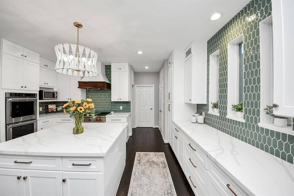 As far as the design elements, they chose light and bright quartz countertops throughout with a color pop backsplash and brash finishes, light fixture, and hardware pulls. Specific design elements and color aesthetic.