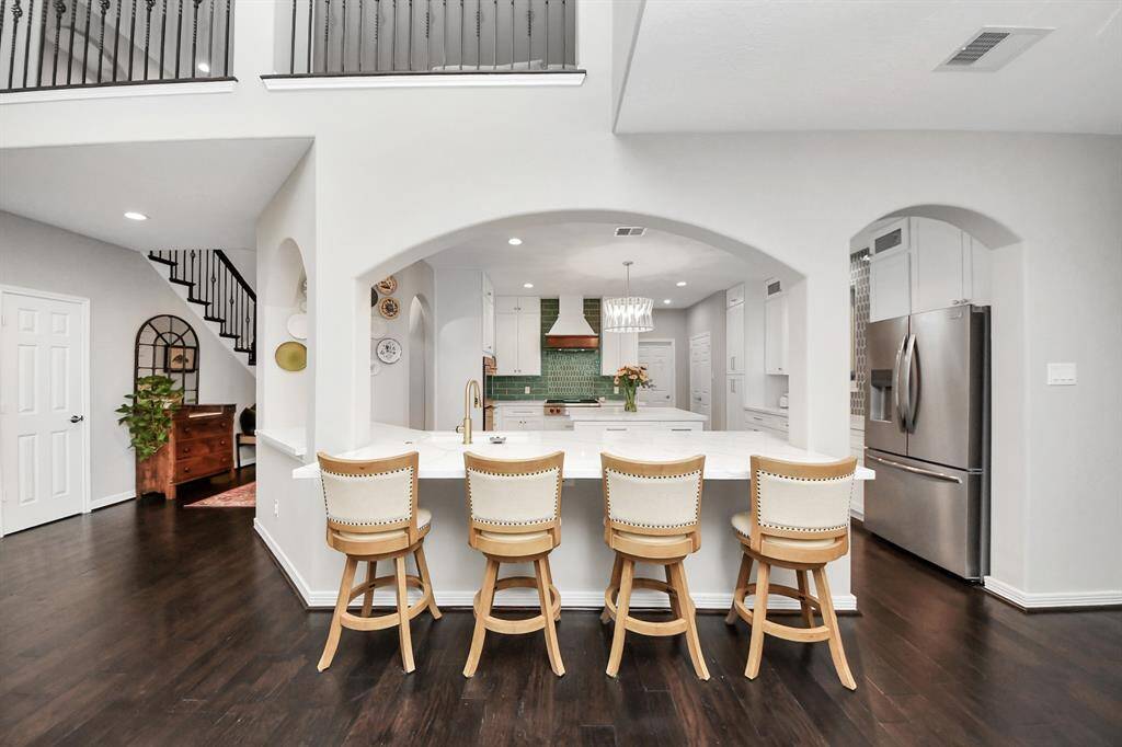 Lastly, the format changes also included dropping the walls to the living room and extending the countertops to create an extended breakfast bar with seating for four. The redesigned kitchen is their dream sports car. It’s beautifully designed in so many ways, but it was truly built for performance and the entertaining showcase space of the home.