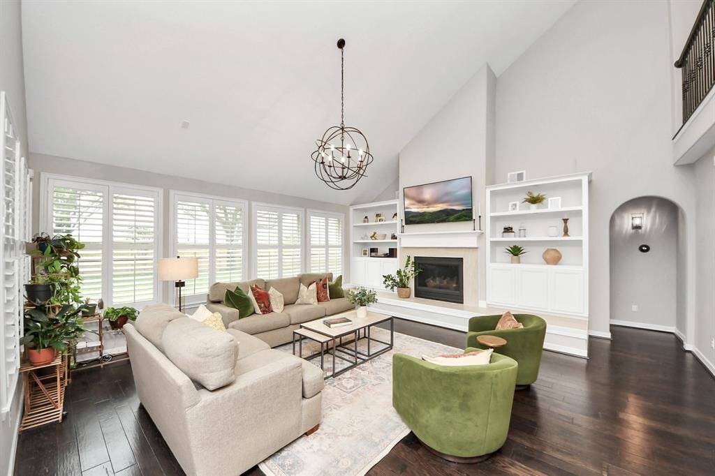The featured living room space focuses on the fireplace with new tile all the way around. The custom built display shelves give you the freedom to customize your design and showcase your story.