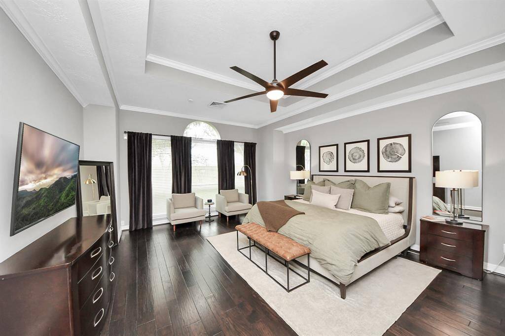 The primary suite is on the first floor. The tall ceilings, and space enough for a seating area is the perfect place for a good book and enough space for the pups to sleep.