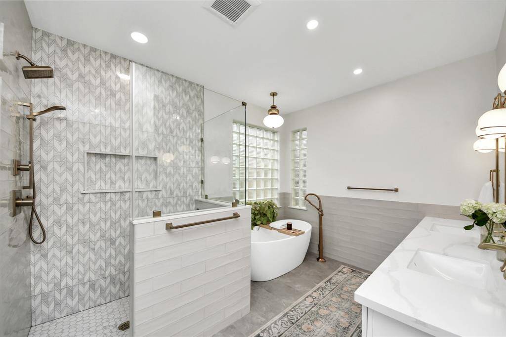 It’s difficult to explain how it was formatted before without a ton of unnecessary paragraphs here, but several designs were painstakingly vetted before tackling this primary bath project. What you see is the end result. The brand new stand up shower with bench, shower cove, brass hardware glass walls and door. The garden soaking tub, and a new extended double vanity with extra storage.