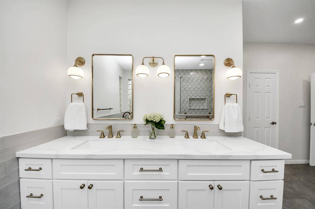 Behind these mirrors you’ll find inset medicine cabinets you never even knew you needed. All brass hardware to match throughout
