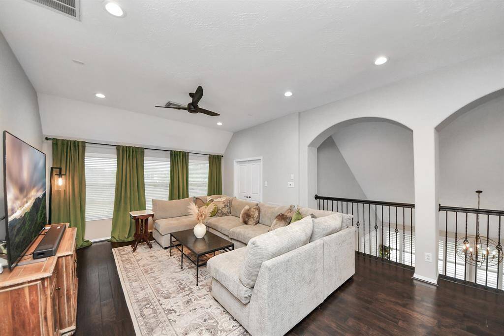 The double doors behind the couch are a massive storage room (2 owners ago used as an office). It has been outfitted with custom designed Elfa shelves and drawers as well.