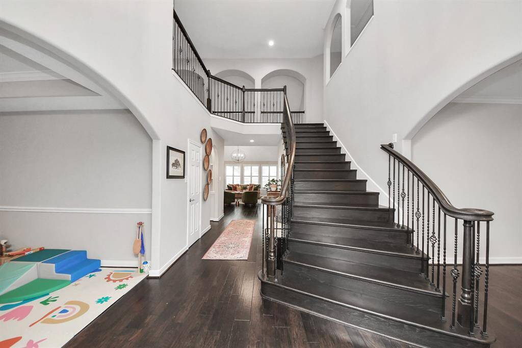When you enter, you’ll see the featured first set of projects they went about tackling prior to moving in, with the reconstructed staircase, dark rich engineered wood floors, and to offset the dark and invite the light, the gray-tone interior paint throughout.