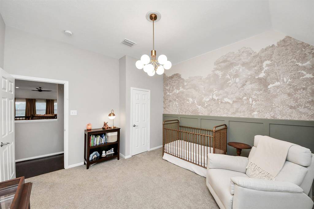 The wallpaper and trim on the feature wall as well as the fixture and paint were done alongside the bathroom renovations in preparation of an expanding family. The walk-in closet is a nice completion to the room.