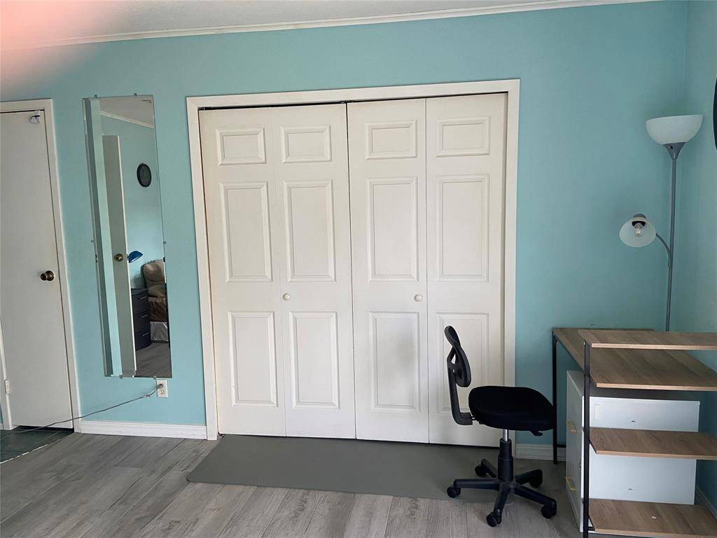 The primary room features two closets, one with white double closet doors.