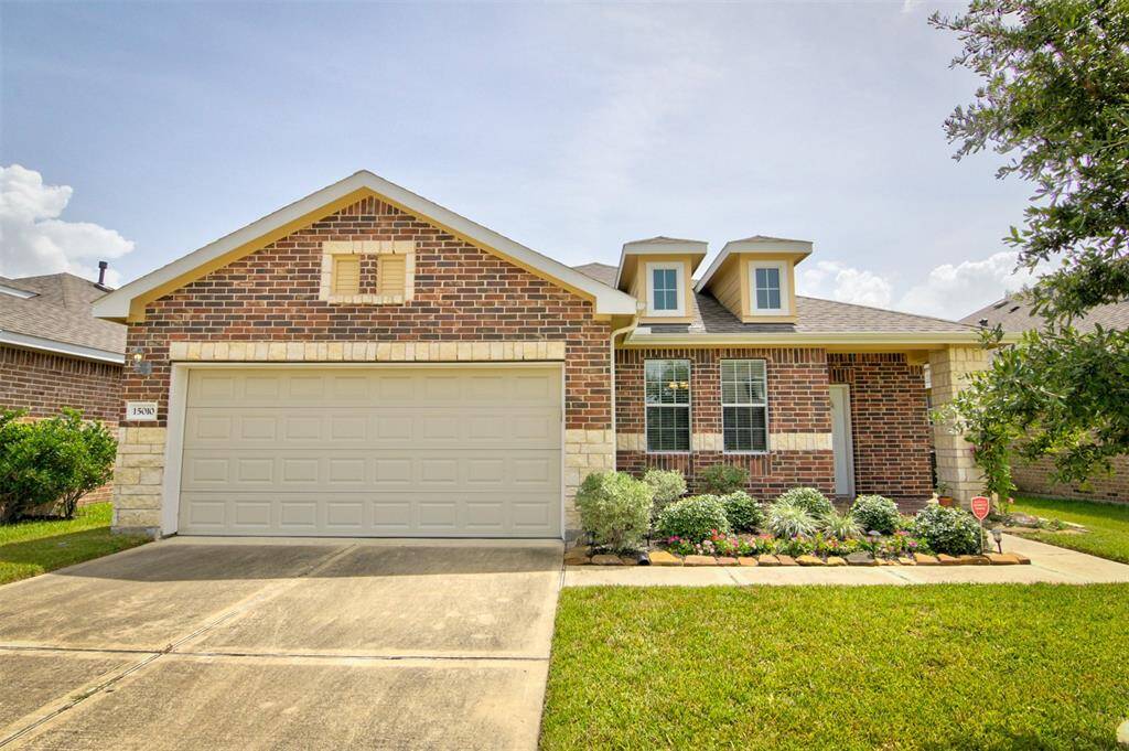 Beautiful one-story, brick/stone home with nice landscaping front and back