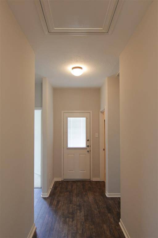 hallway leads to bedrooms, baths, laundry, and door to backyard
