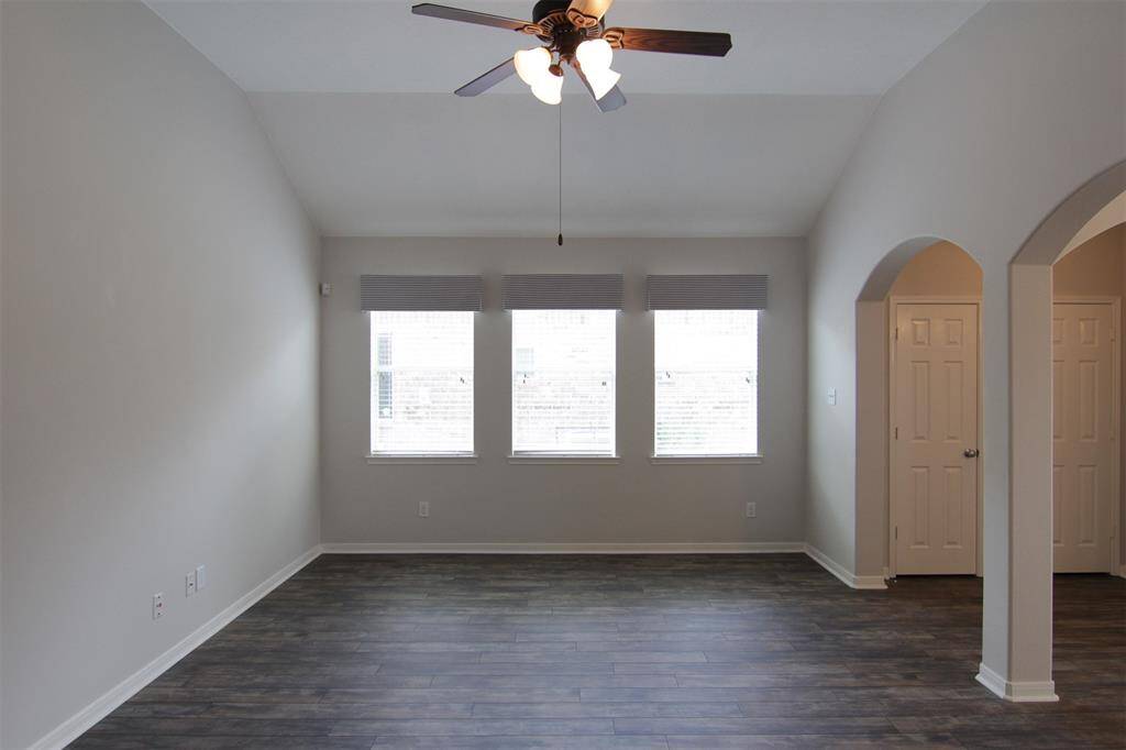 living room with vaulted ceiling & ceiling fan