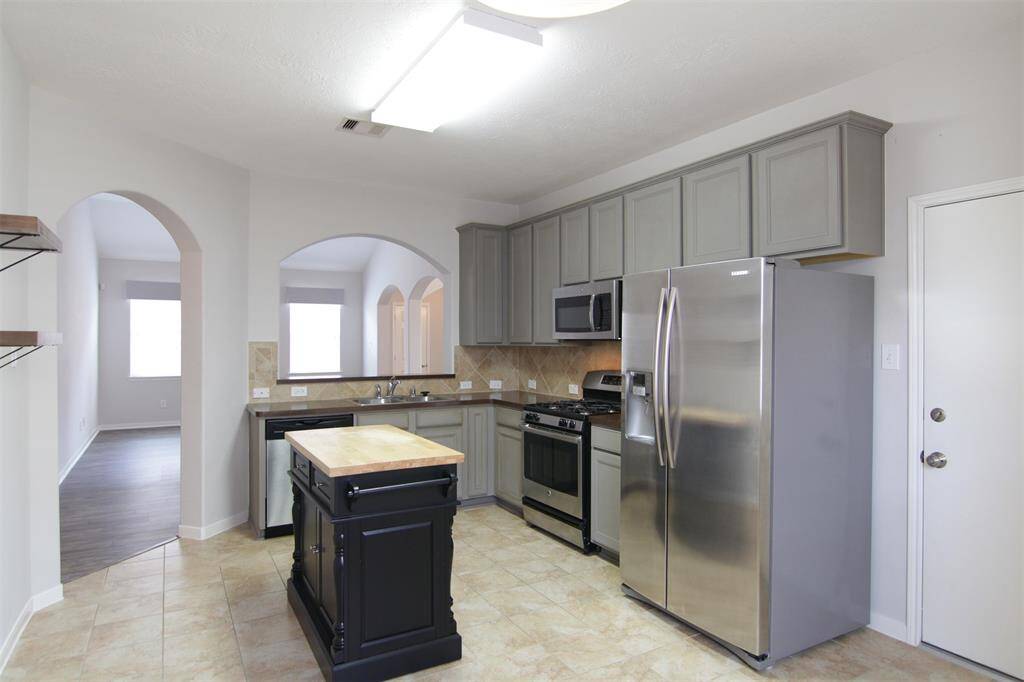 all stainless-steel appliances included, door to garage