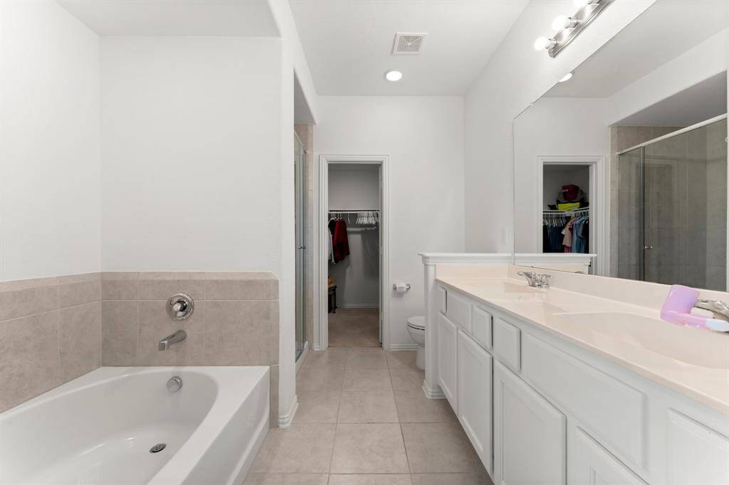 Primary Bath with double vanity, soaking tub and separate shower.