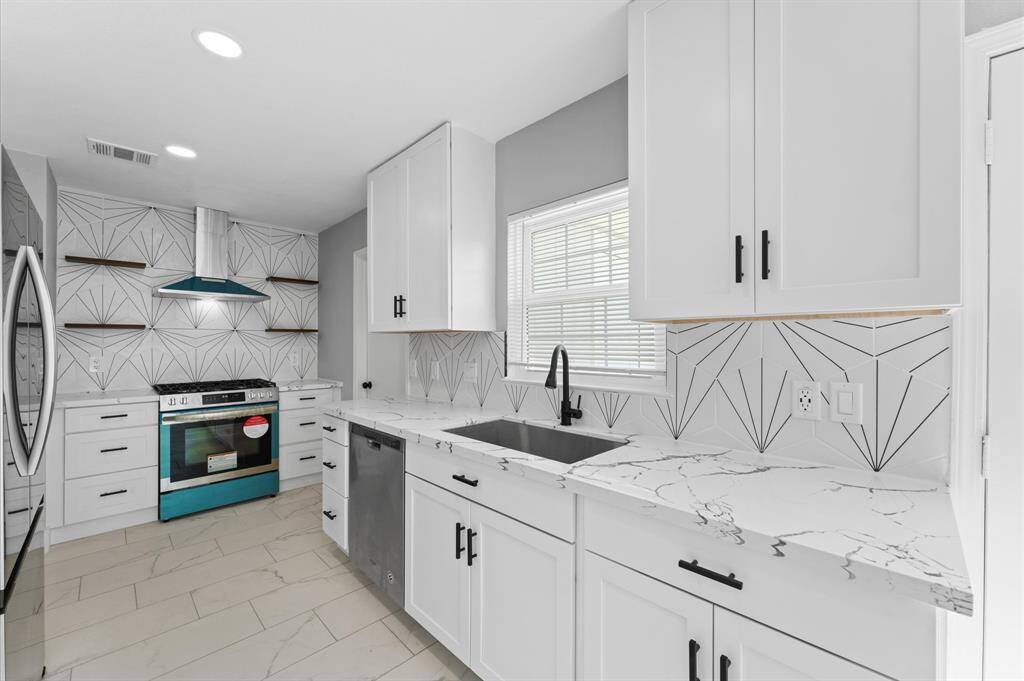 Stylishly remodeled kitchen featuring a one-of-a-kind tile backsplash-where function meets flair.