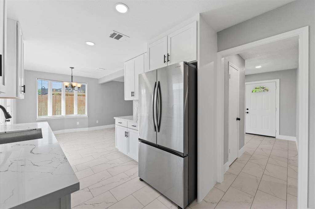 Another view of the fabulous kitchen, dining room and entryway with hall closet.