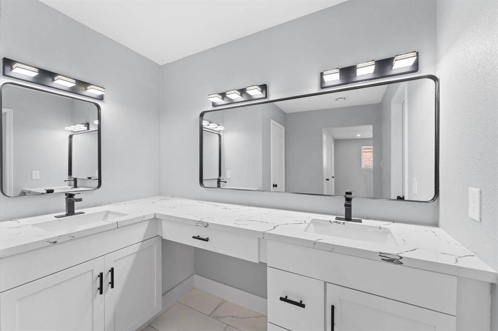 Sophisticated style meets everyday function in this beautifully remodeled ensuite with dramatic finishes and dual linen closets.