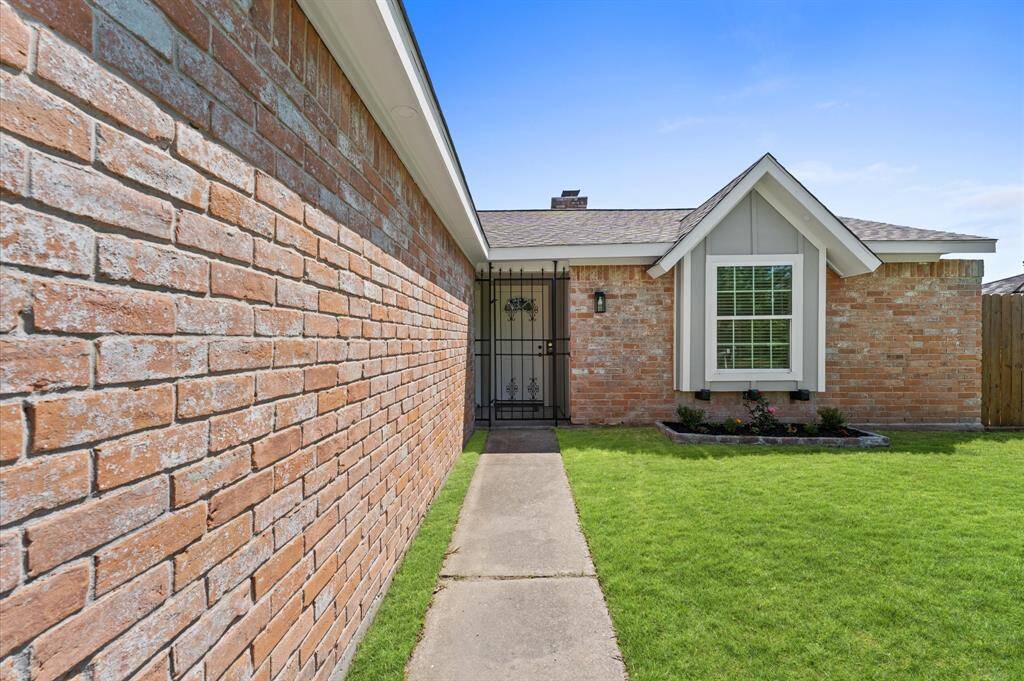 Inviting walkway and bright, spacious window with a scenic view of the front yard-natural light meets serene surroundings.